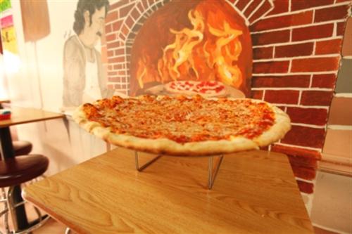 Pizza coming out of the oven.