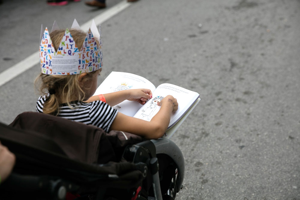 A little girl enjoying a Nancy Clancy book.
