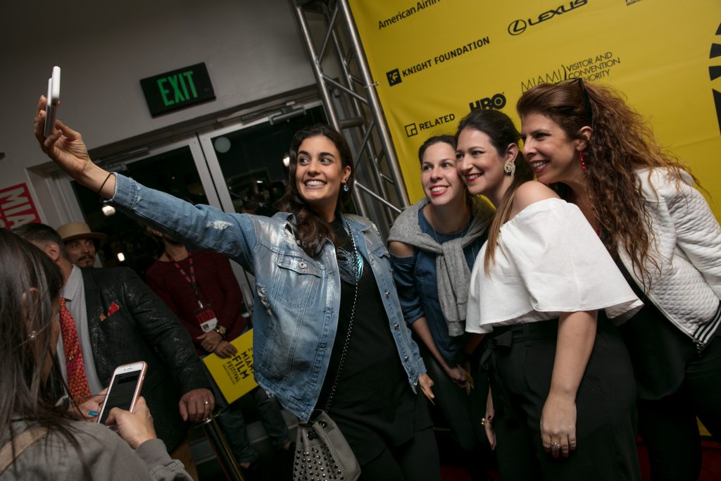Fans taking a selfie with producer Nathalie Sar-Shalom. Miami Film Festival