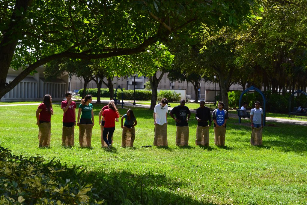 Students competing in a potato sack race.