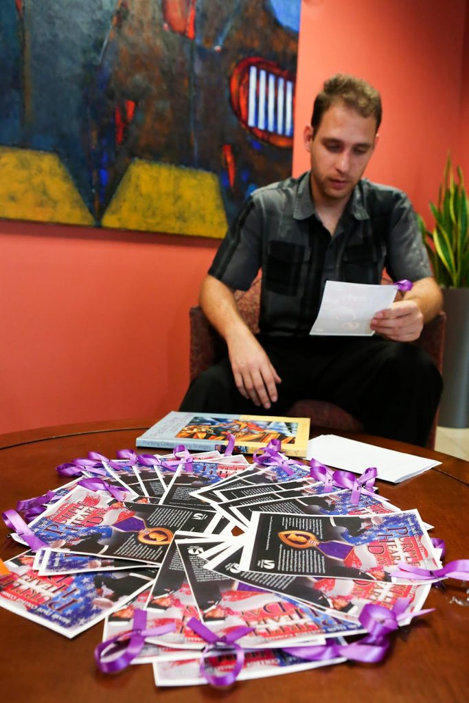 Student reading note with purple ribbon.