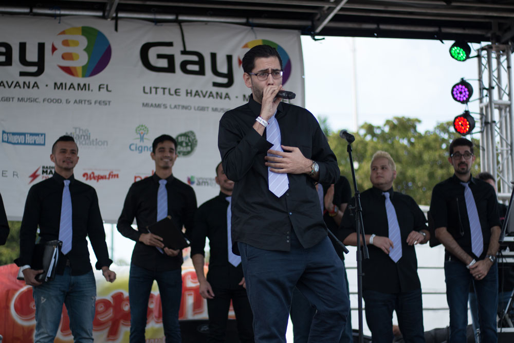 Adrian Toca of the Miami Gay Men Chorus performing on stage.