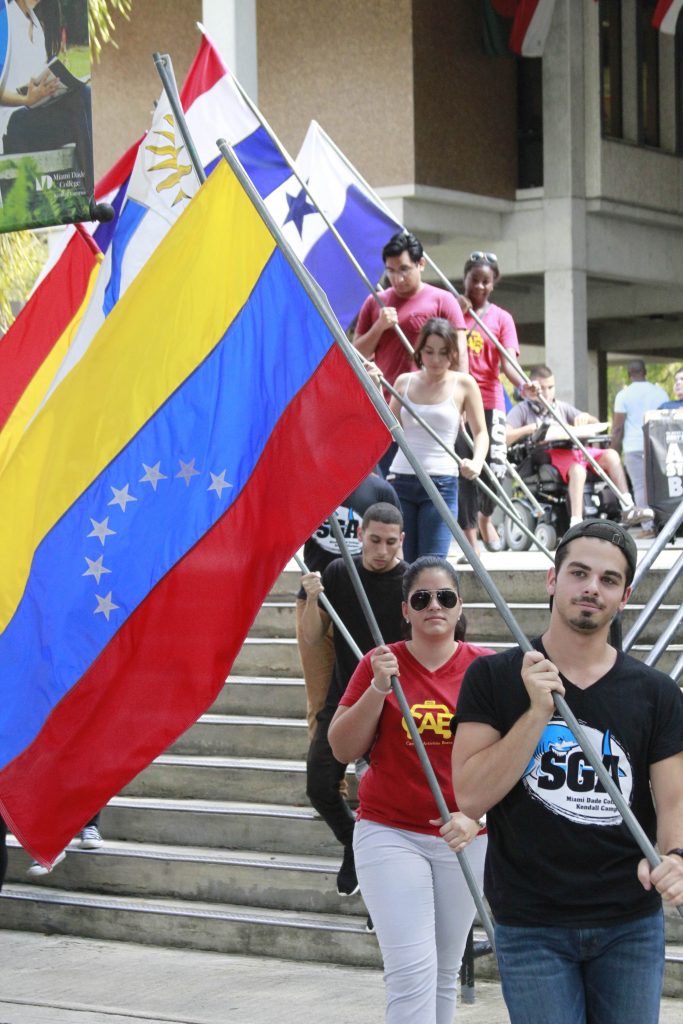 Students holding various flags of Hispanic countries.