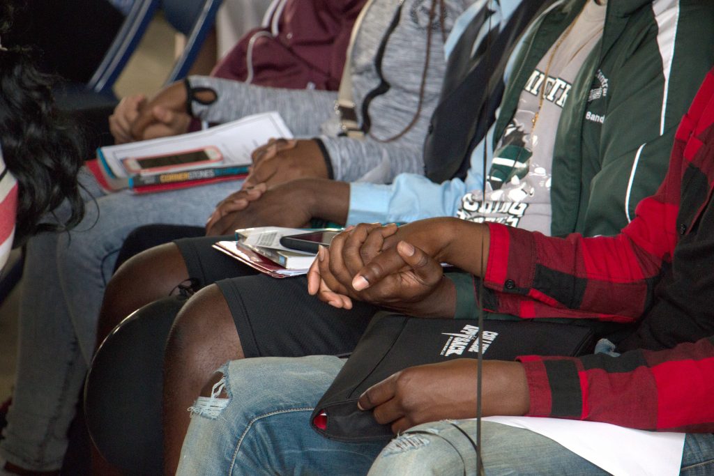 Students holding hands.