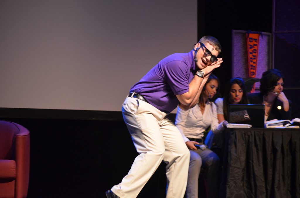 Honors College student performing on stage.