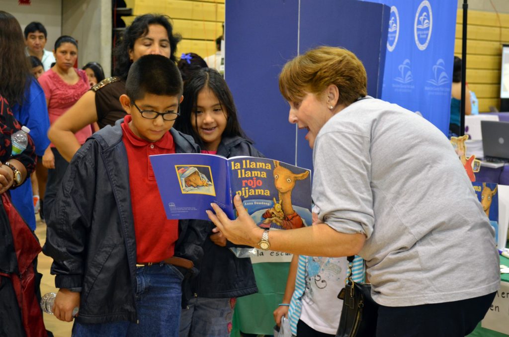 A faculty member reading to children.