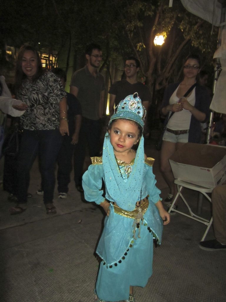 Little girl showing off her costume.