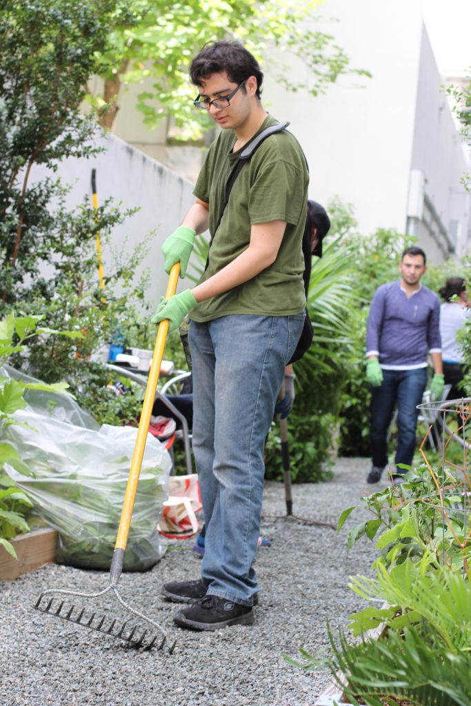 A student raking gravel.