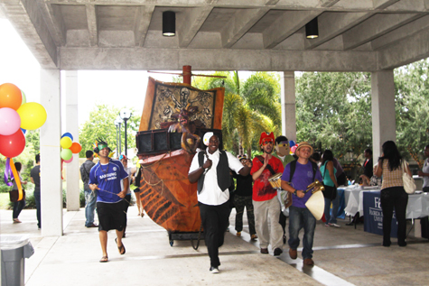 Students parading down the hallways of Kendall Campus with the life-size paper boats.
