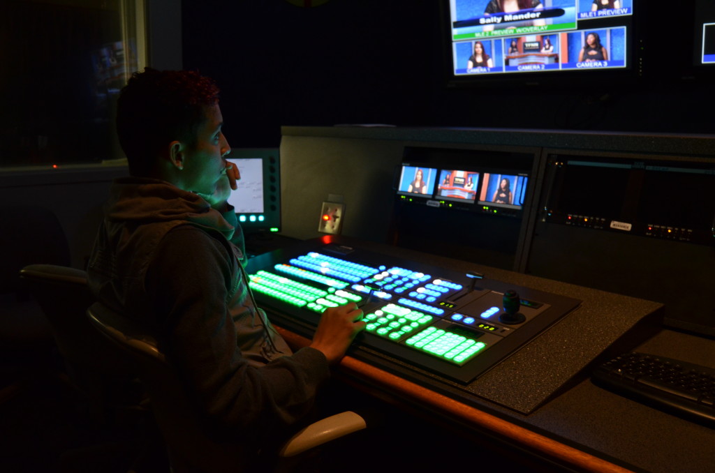 All Eyes On The Screen: Christophe Blaize, a student at North Campus, observes the monitors in the control room of the MDC TV studio. PETER CARRERA THE REPORTER
