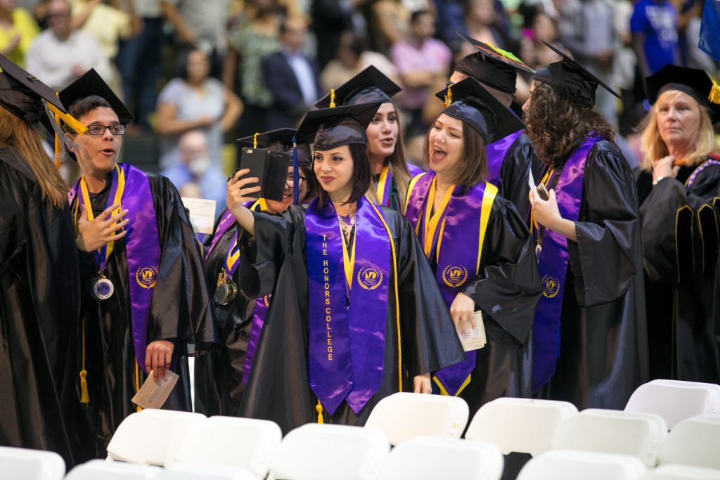 A student taking a selfie at graduation.