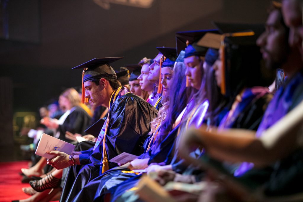 Student taking a moment to reflect during the Kendall campus graduation ceremony.