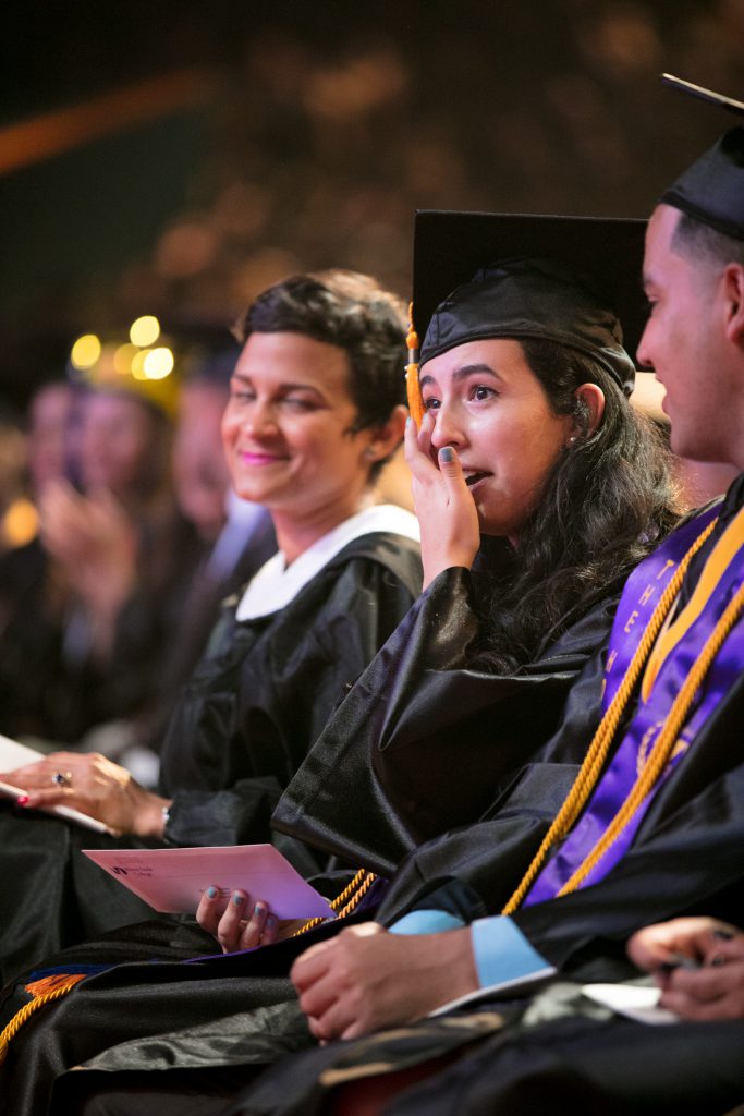A student wiping a tear away.