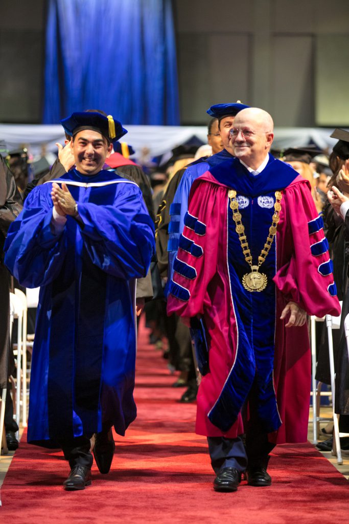 MDC president Padron and Hialeah Campus president Martinez walking down to the stage.
