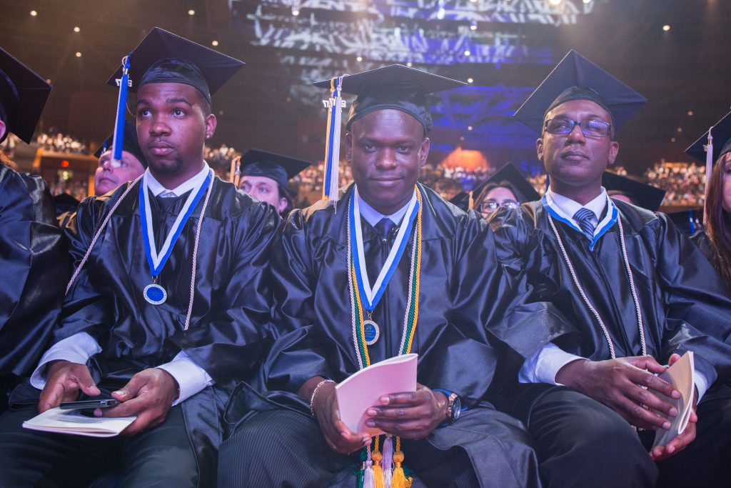 Students waiting for their name to be called at graduation.