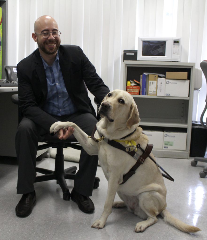 Photo of Gabriel Lopez Kafati with his guide dog Posh.