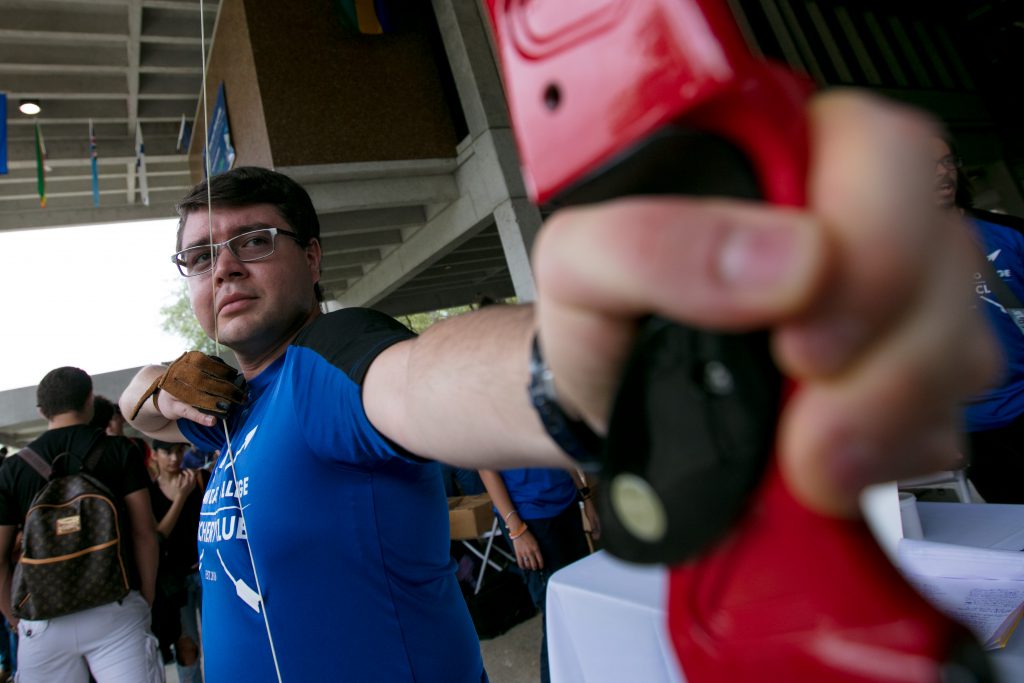 Student posing with his bow and arrow.