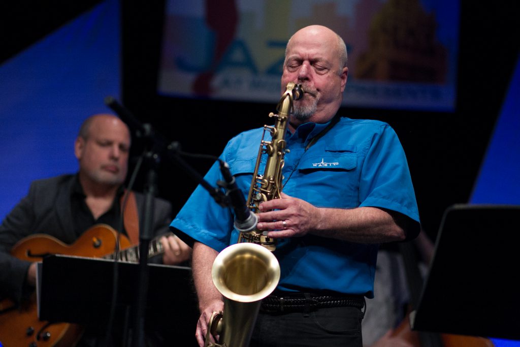 Saxophonist Mark Colby performing on stage.