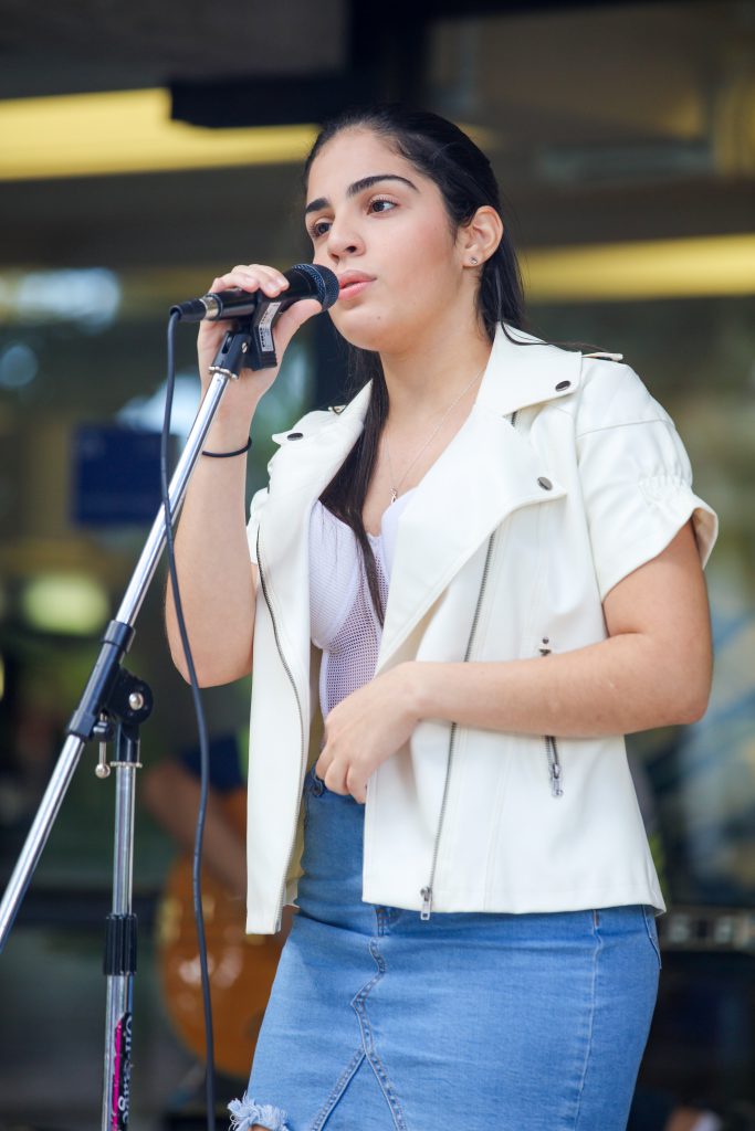 Isairis Rodriguez singing on stage.