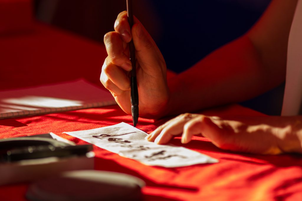 Volunteer Mona Liu writing in Chinese.