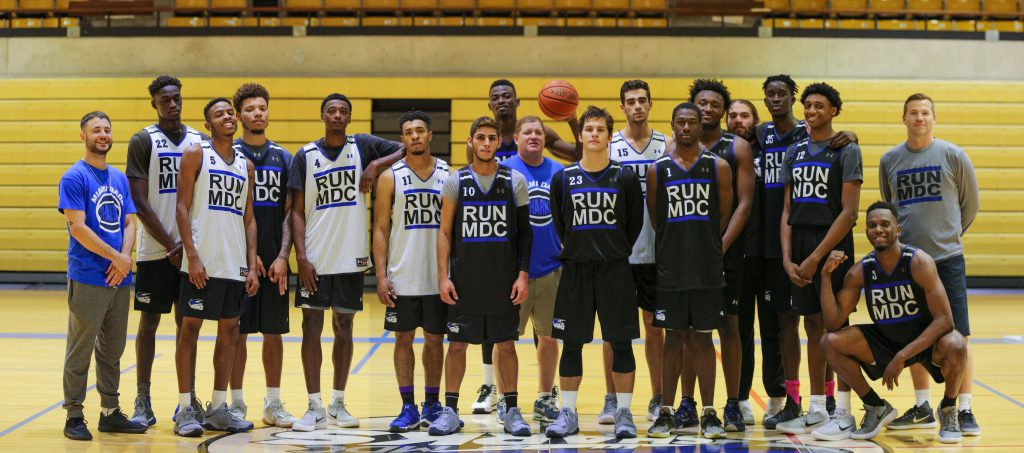 The men's basketball team posing for the camera.
