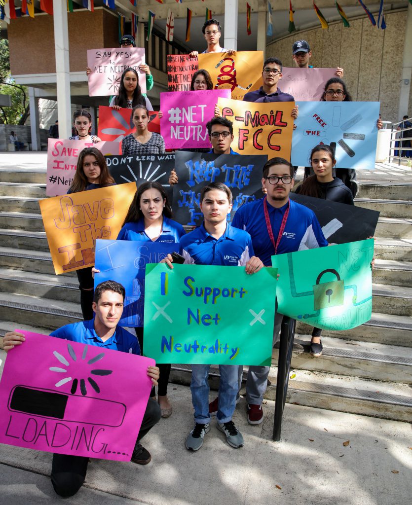 Students holding up their signs to protest for Net Neutrality.