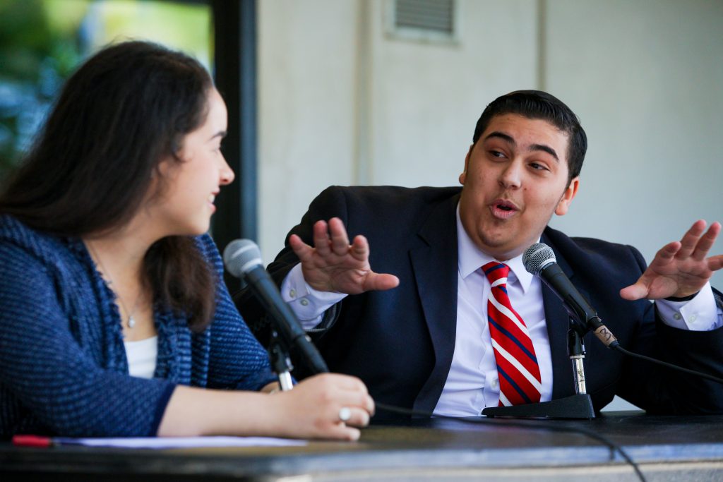 Juliana Sanches and Marlon Montero debating.