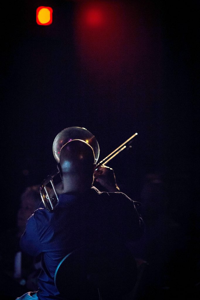 Director and trombonist Craig Harris playing his instrument.