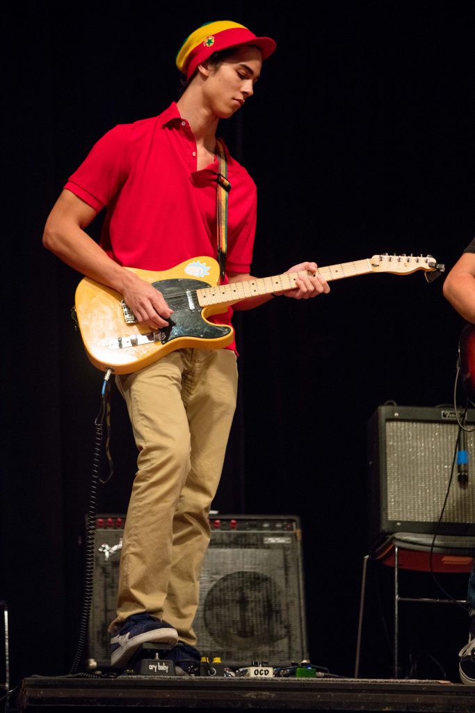 Student playing his guitar.