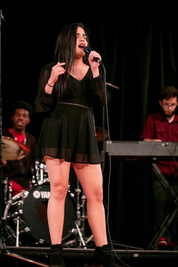 Student singing on stage.