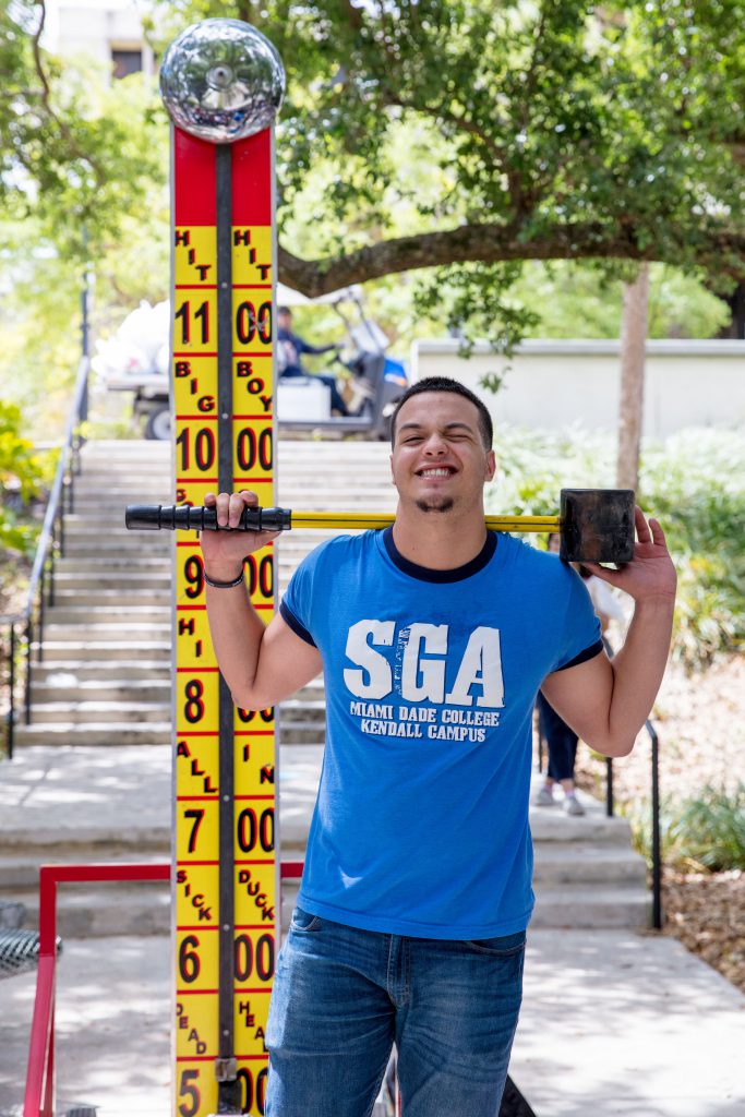 Student government association senator Frank Pererra holding the hammer.