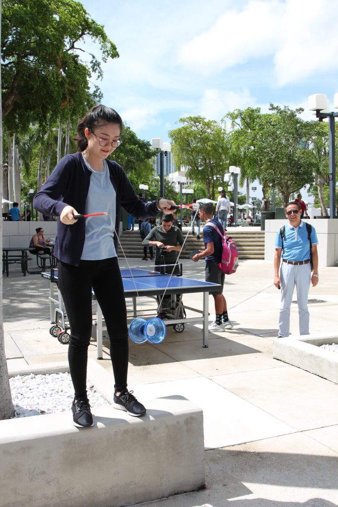 A graduate assistant playing with a diabolo, a Chinese toy similar to a yo-yo.