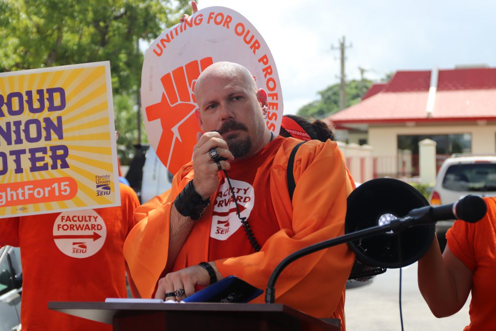 An adjunct professor speaking at the rally.