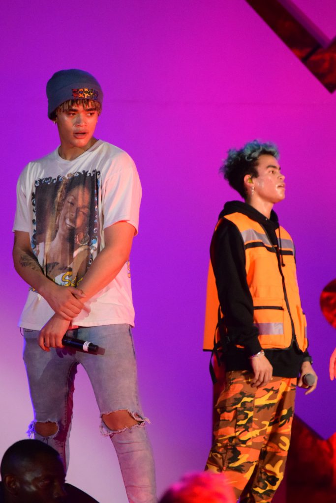 Members of PRETTYMUCH performing on stage.
