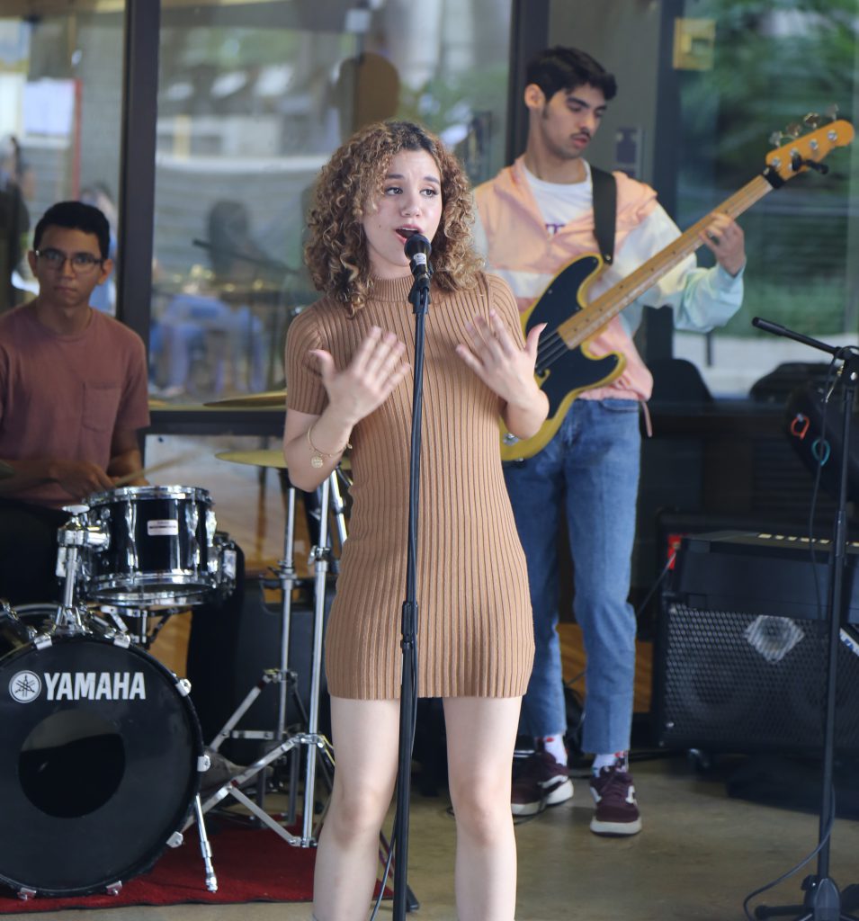Student singing in front of KoffeeHouse.