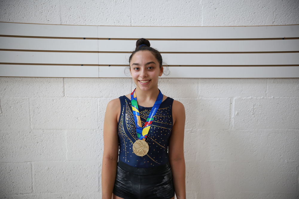 Bianca Leon posing for the camera with her gold medal.