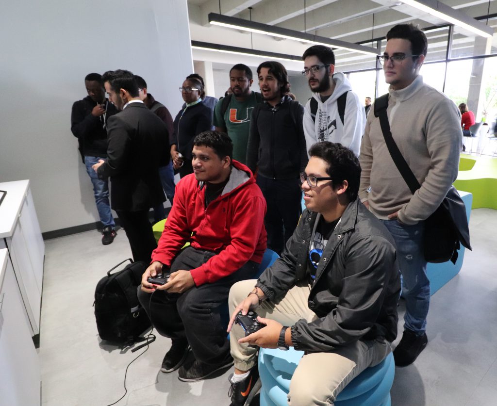 Students playing video games in the rec room.