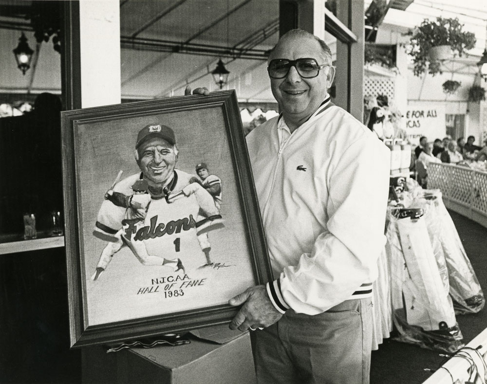 Demie Mainieri holding an artwork dedicated to him.