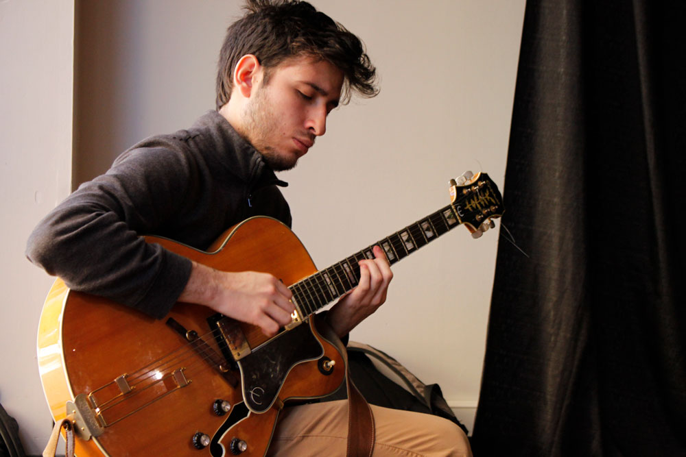 Student playing guitar.