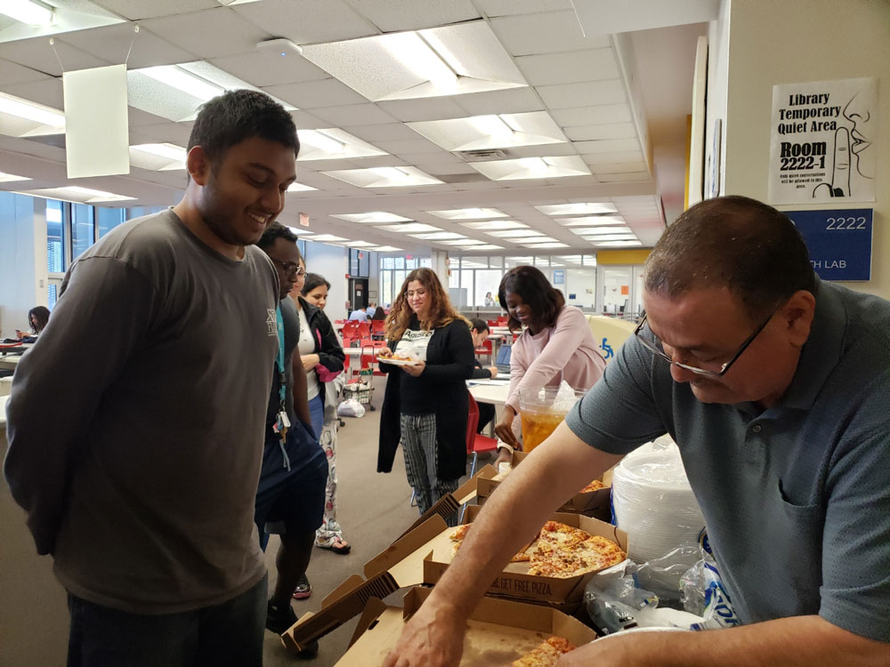 Mourad passing out pizza.