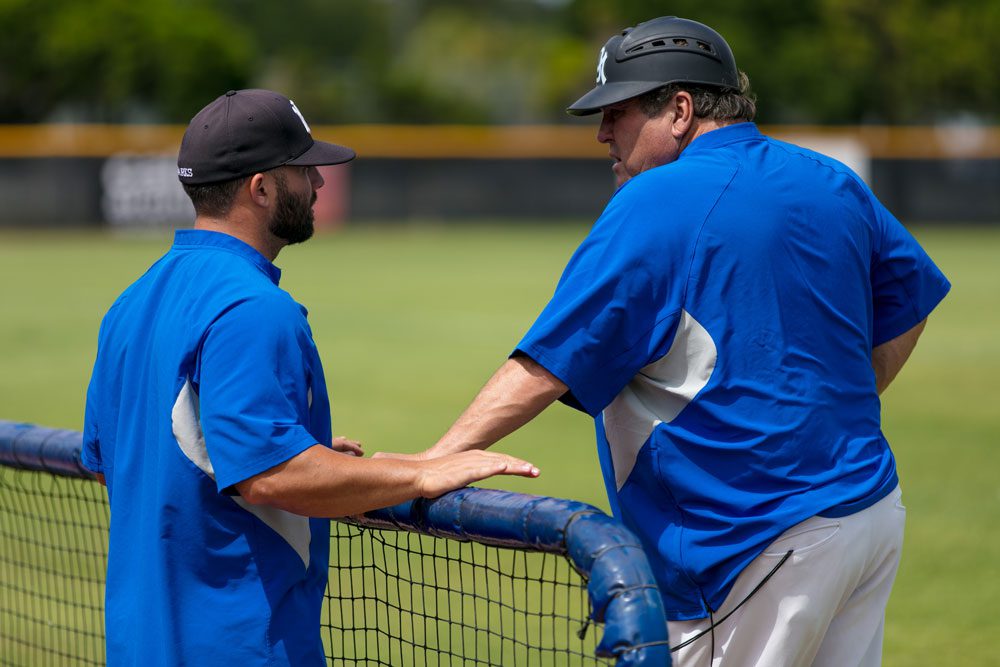 Coach Danny Price speaking with assistant coach.