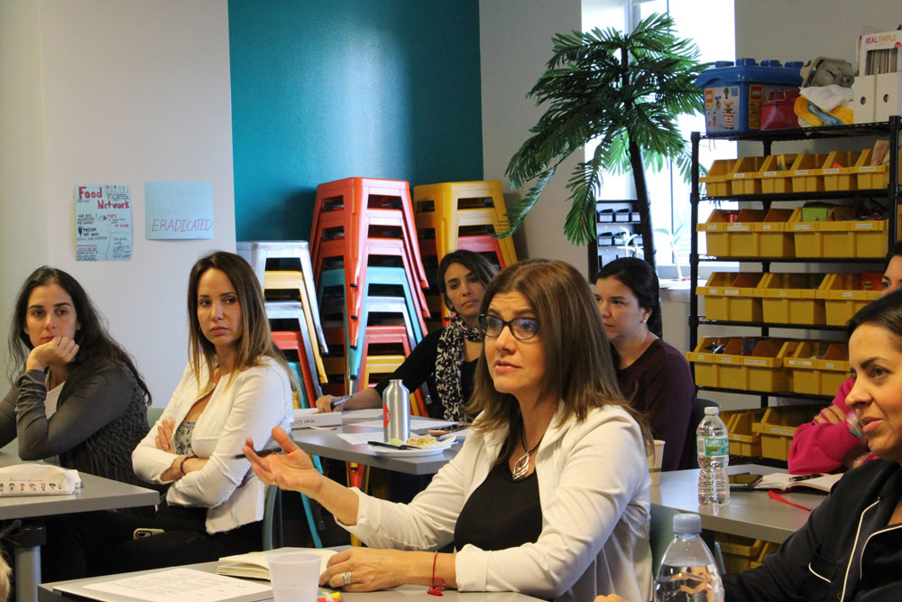 Female Venezuelan students discussing in class.