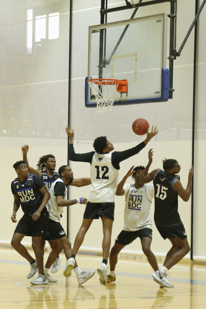 MDC men's basketball team on the court.