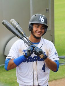 Shortstop Raphy holding two bats.