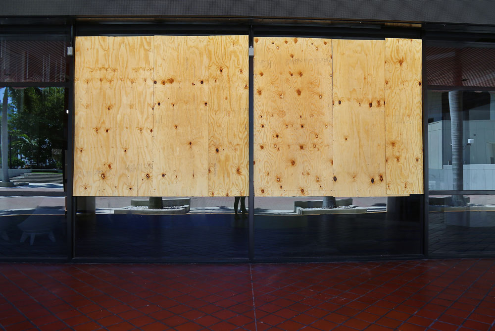 Brokens windows covered with plywood due to George Floyd protests.